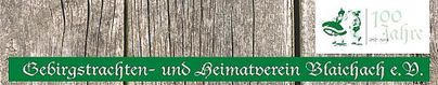 Ein Banner des Gebirgstrachten- und Heimatvereins Blaichach e.V. mit der Aufschrift „100 Jahre“. Der Hintergrund zeigt eine Holztextur.