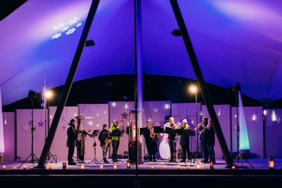 Mehrere Personen spielen Musikinstrumente auf der Seebuehne am Grossen Alpsee bei Immenstadt zur Weihnachtszeit.