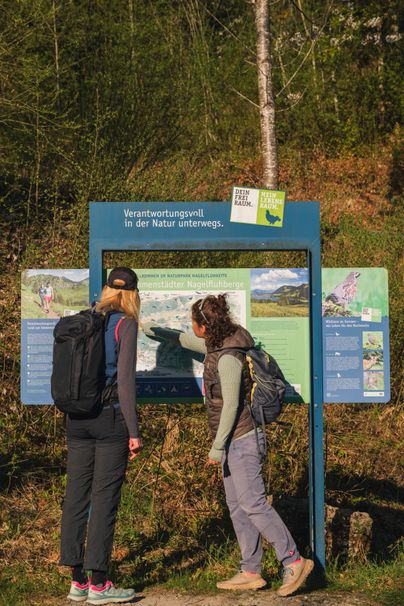 Zwei Frauen vor einer großen Wandertafel 